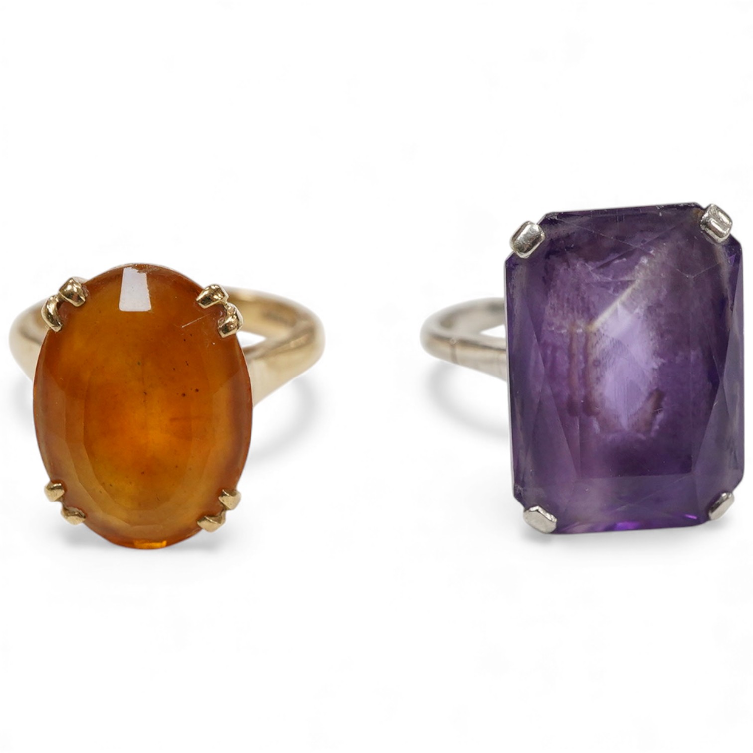 Two dress rings: one a rectangular cut amethyst set in platinum, size M and a 9ct gold and oval cut citrine, size L.